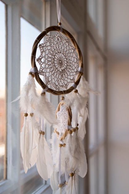 Free Photo dreamcatcher hanging in the front of the windows