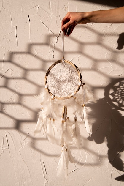 Free Photo dreamcatcher held by hand in the sun