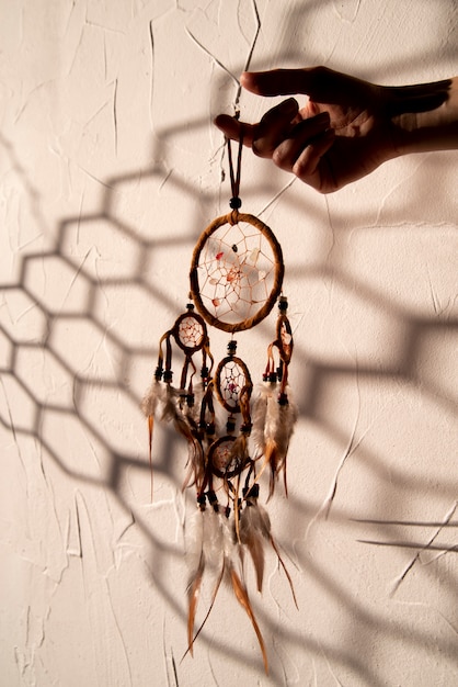 Free Photo dreamcatcher held by hand in the sun