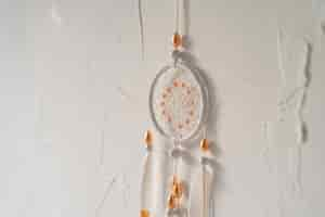 Free photo dreamcatcher placed on a white wall