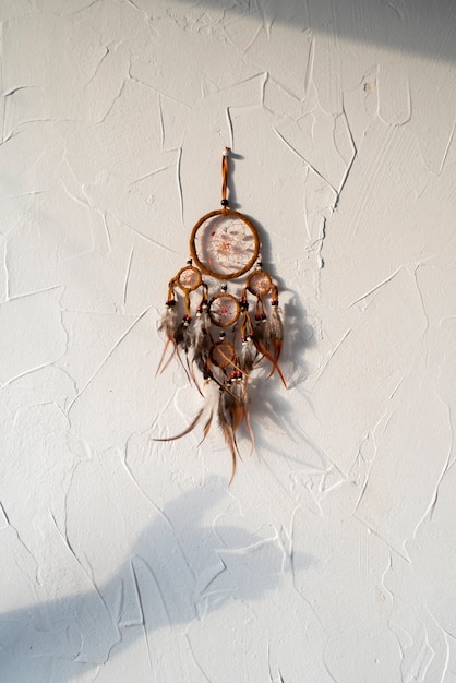 Free Photo dreamcatcher placed on a white wall