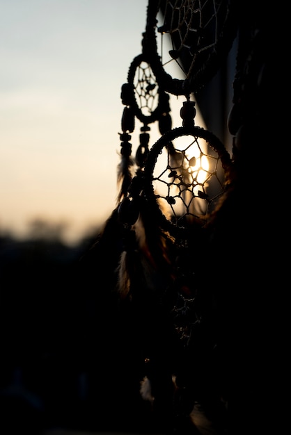 Free photo dreamcatcher at sunset in the shadow