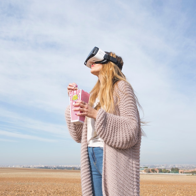 Free photo dreaming girl in vr glasses in countryside