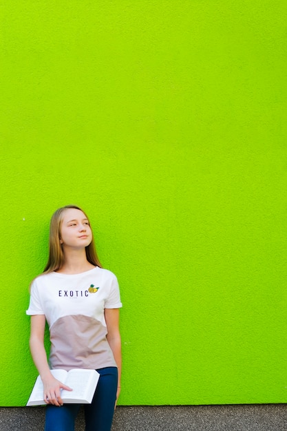 Dreaming girl with textbook