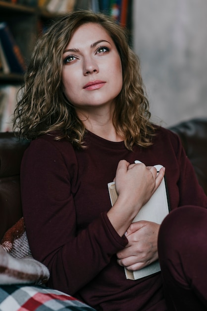 Dreaming woman with book