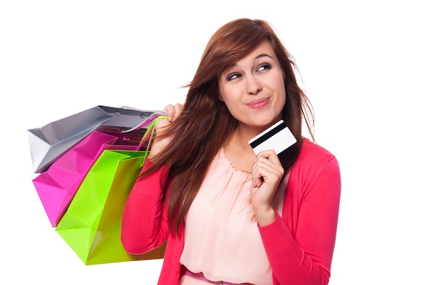 Dreaming woman with shopping bags and credit card