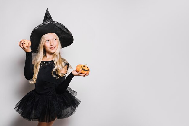 Dreamy little witch with jack-o-lanterns