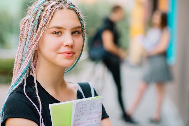 Free Photo dreamy teen schoolgirl with textbook