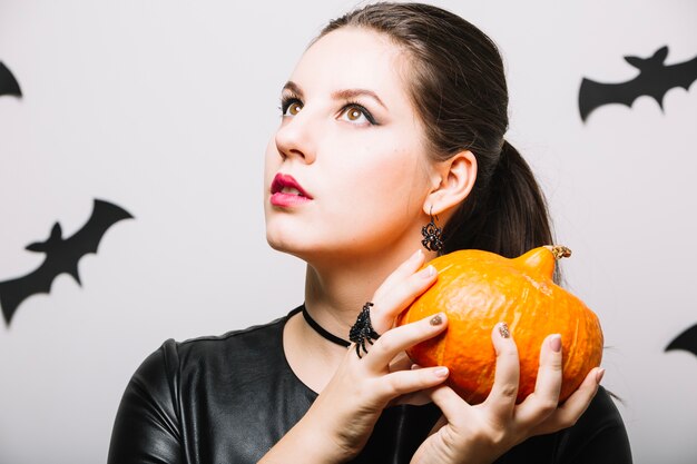 Dreamy woman with pumpkin