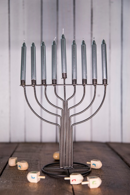 Free Photo dreidels lying on table near menorah