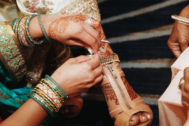 Dressing up shoes for the indian bride before the wedding