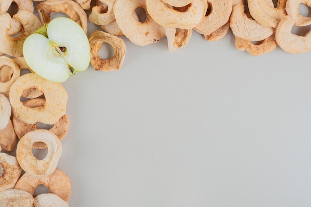 Free photo dried apple fruit with a slice of fresh apple .