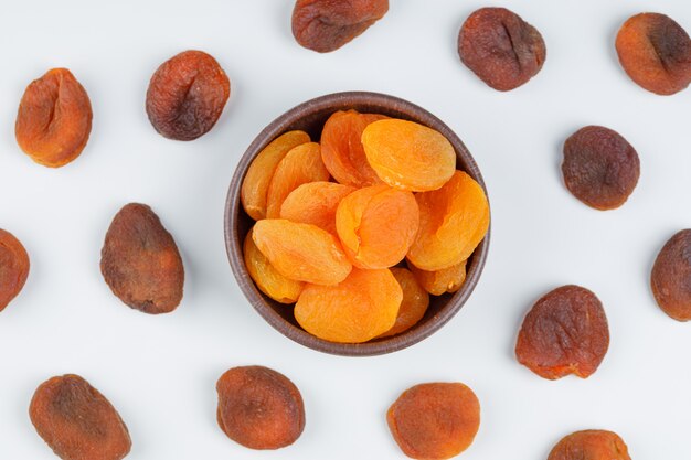 Dried apricots in a clay bowl. top view.