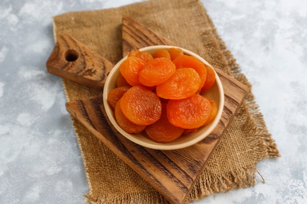 Free Photo dried apricots on light concrete 