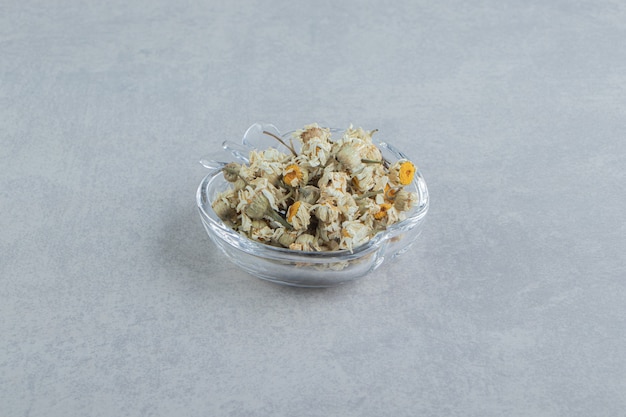 Free Photo dried chamomile flowers in glass bowl. 