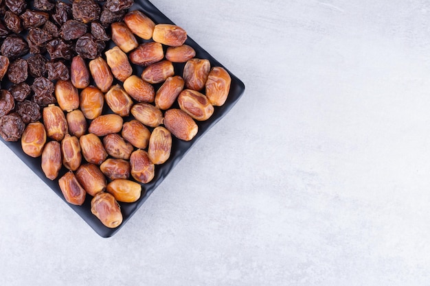 Free photo dried cherries, berries and dates on a wooden platter. high quality photo