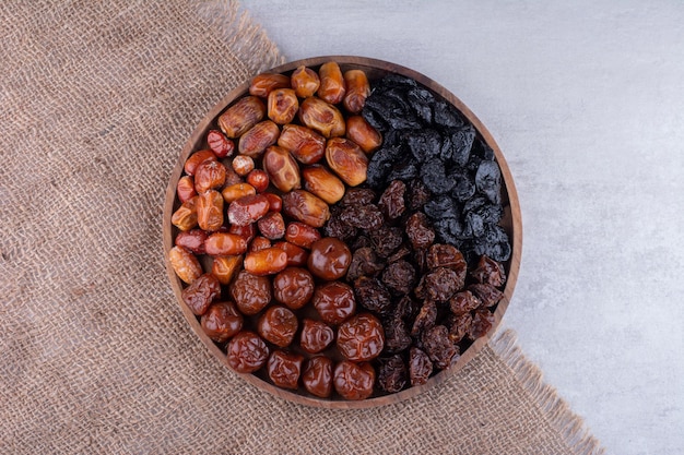 Free photo dried cherries, berries and dates on a wooden platter. high quality photo