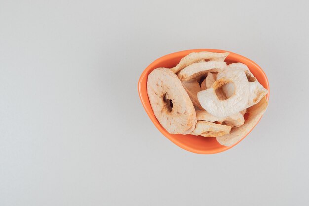 Dried fruit slices in orange bowl