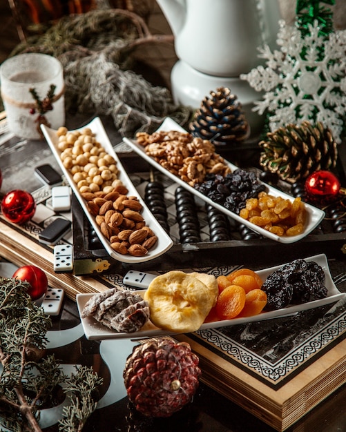 Free photo dried fruits and nuts in plates