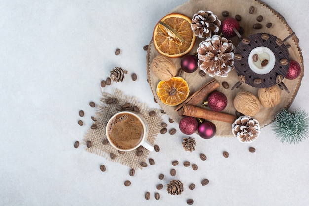 Free Photo dried fruits with walnuts and cup of coffee on white background. high quality photo