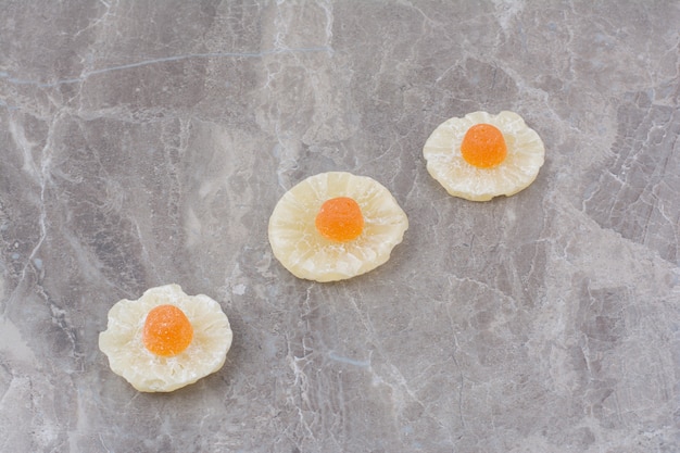 Free photo dried healthy fruits with sweet marmalade on marble background.