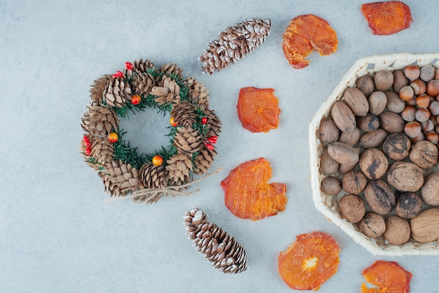 Dried healthy orange with basket full of nuts. High quality photo