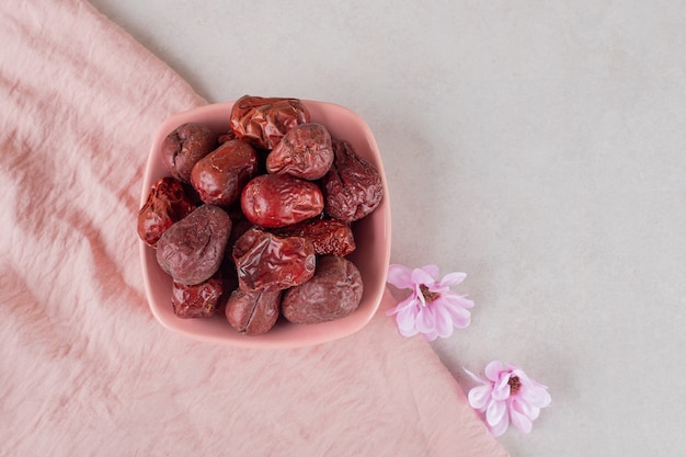 Free photo dried indian jujube berries in a ceramic cup.