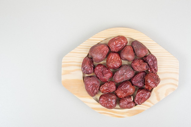 Dried oleaster fruits on wooden plate