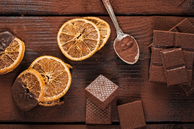 Dried orange slices with melted chocolate and waffles