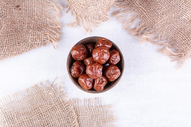 Dried plum cherries in a cup on concrete background. High quality photo