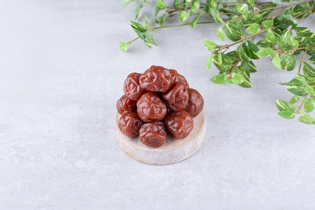 Dried plum cherries in a cup on concrete background. High quality photo