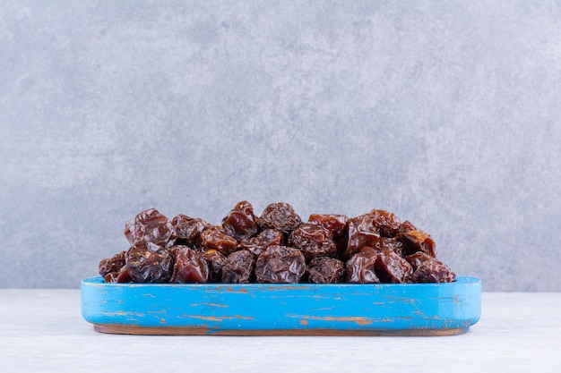 Dried sour cherries in a cup on concrete background. High quality photo