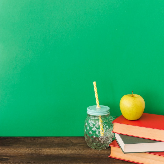 Free photo drink jar near apple and books