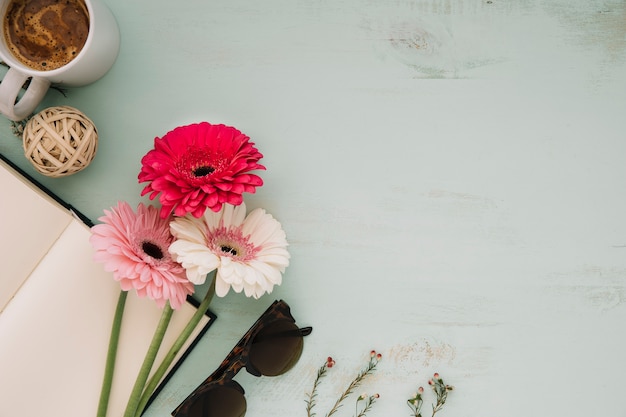 Drink near flowers and notebook