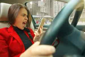 Free photo driving around city. young attractive woman driving a car