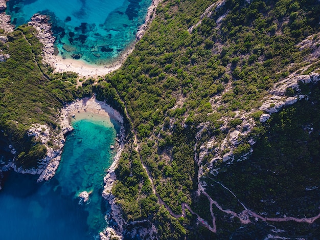 Drone shot of breathtaking shore of Porto Timoni with deep tropical blue and clear turquoise sea