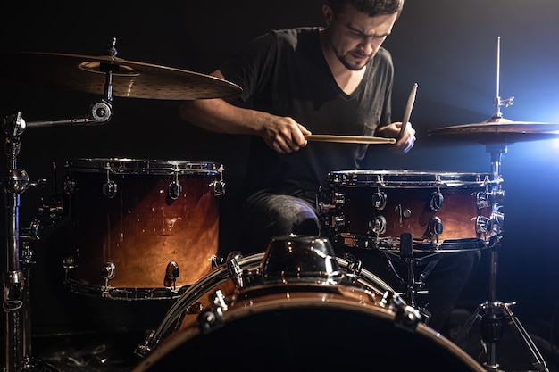 Free Photo the drummer plays drums while sitting at the drum kit on stage.