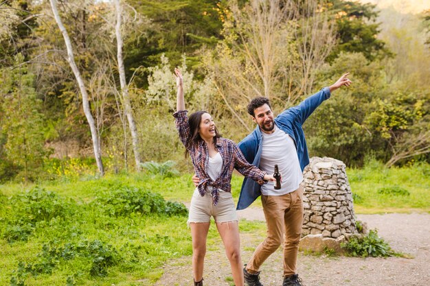 Drunk couple having fun in forest