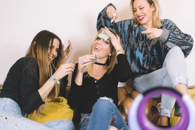 Free photo drunk woman laughing on sofa