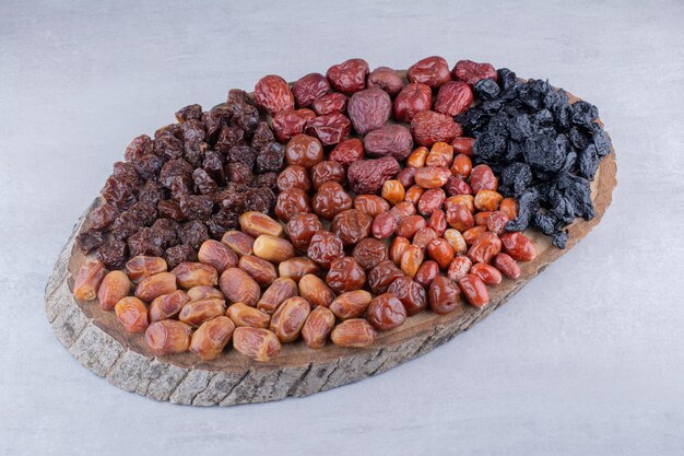 Dry fruits combination on a wooden platter. High quality photo