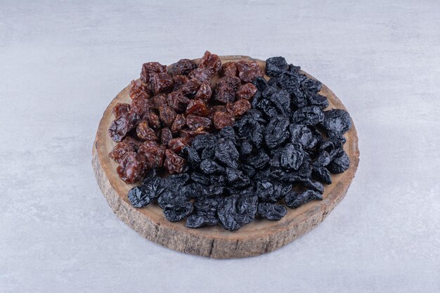 Dry fruits combination on a wooden platter. High quality photo