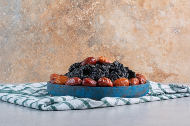 Free photo dry fruits platter isolated on concrete background.