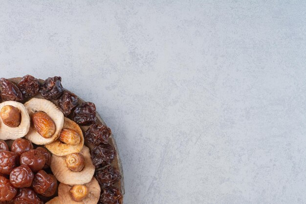 Dry fruits platter isolated on concrete background.