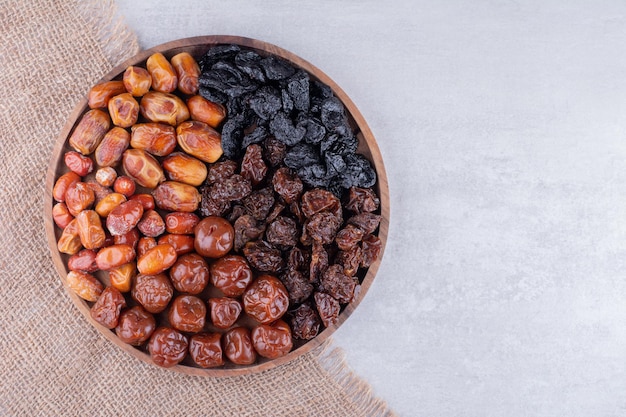 Dry fruits set with dates and cherries on a wooden platter. High quality photo