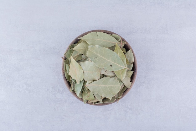 Dry green bay leaves in a bowl. High quality photo