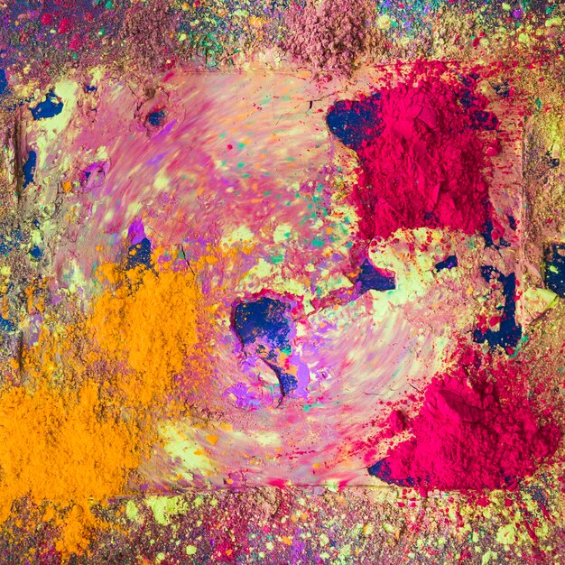 Dry multicolor powder on dark table