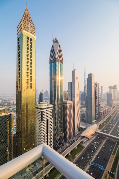 Free photo dubai skyline and downtown skyscrapers on sunset. modern architecture concept with highrise buildings on world famous metropolis in united arab emirates