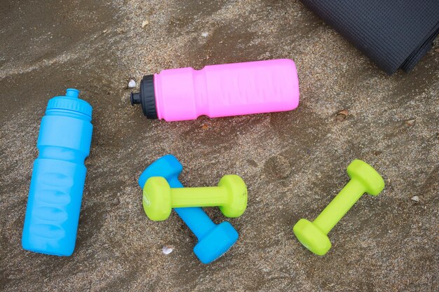 Dumbbell water bottle at the beach on sand High quality photo