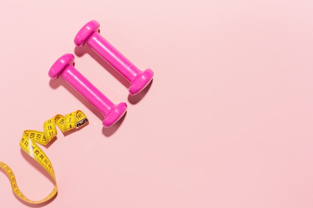 Free Photo dumbbells flat lay on pink background