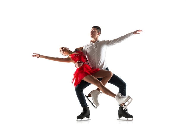 Duo figure skating isolated on white wall with copyspace. Two sportsmen practicing and training in action and motion.